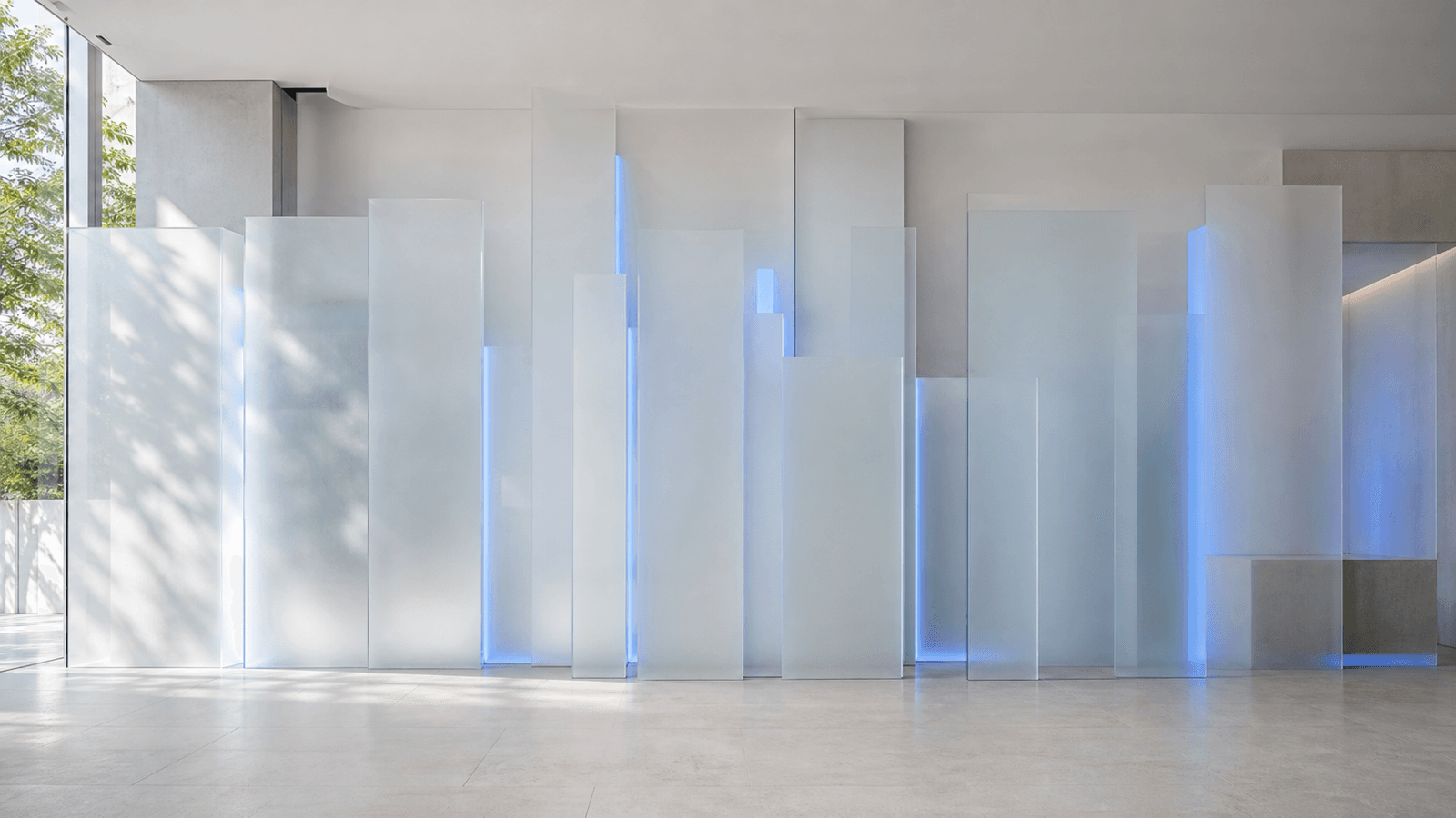 A wall of frosted glass panels at varied depths, each faintly backlit with cobalt glow